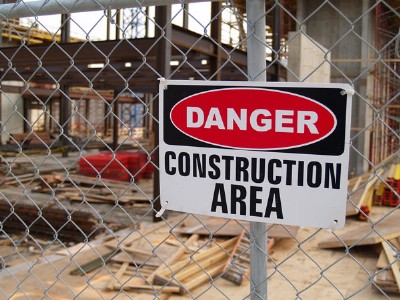 Temporary chain link fence rental with a sign attached that reads "Danger: Construction Area"